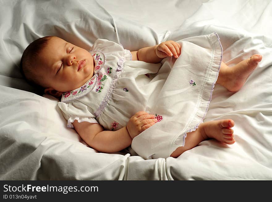 A little cute baby portrait over white sleeping. A little cute baby portrait over white sleeping