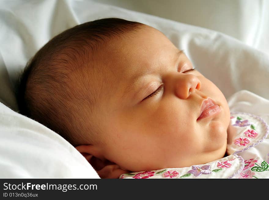 A little cute baby portrait over white sleeping. A little cute baby portrait over white sleeping