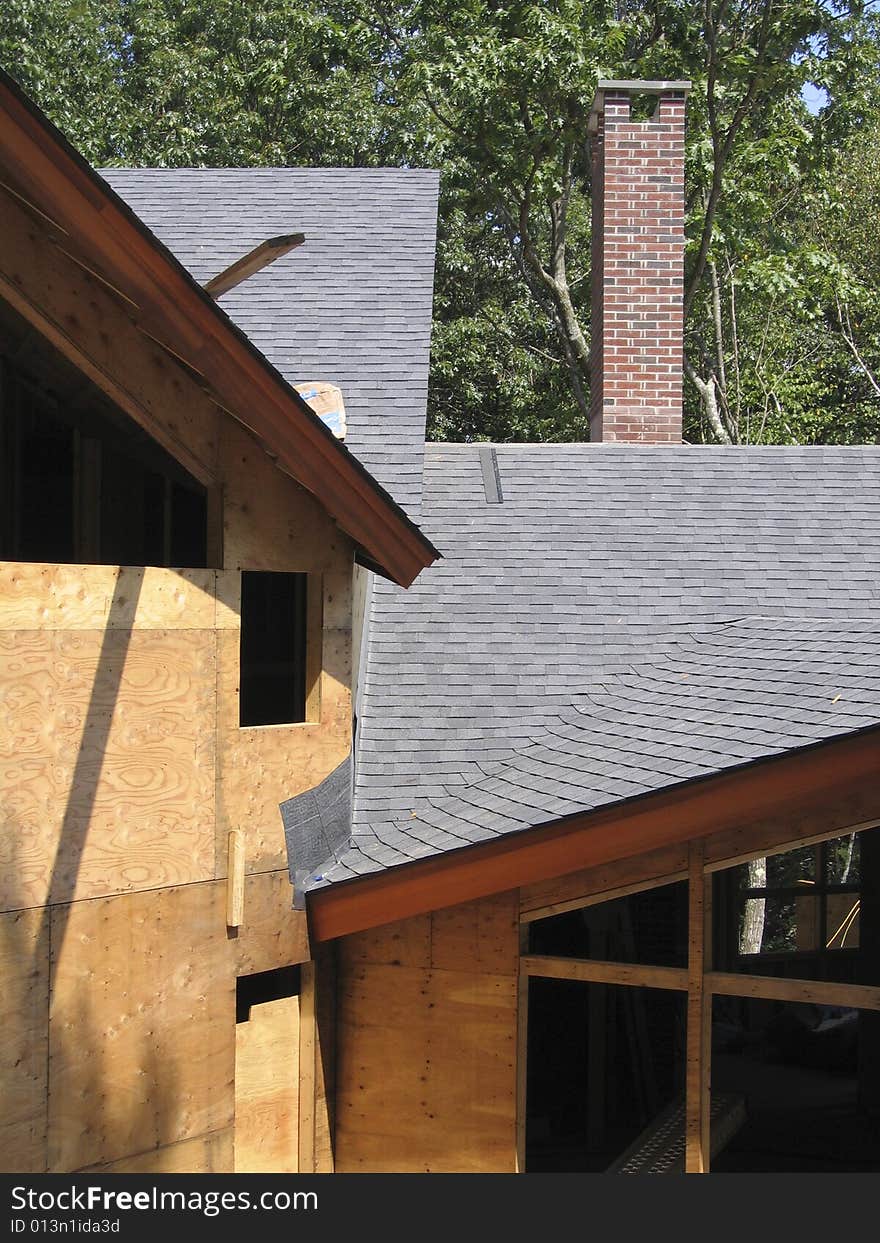 Construction showing completed roof, and chimney, with sheathed but un-sided walls, and frames for windows. Construction showing completed roof, and chimney, with sheathed but un-sided walls, and frames for windows.