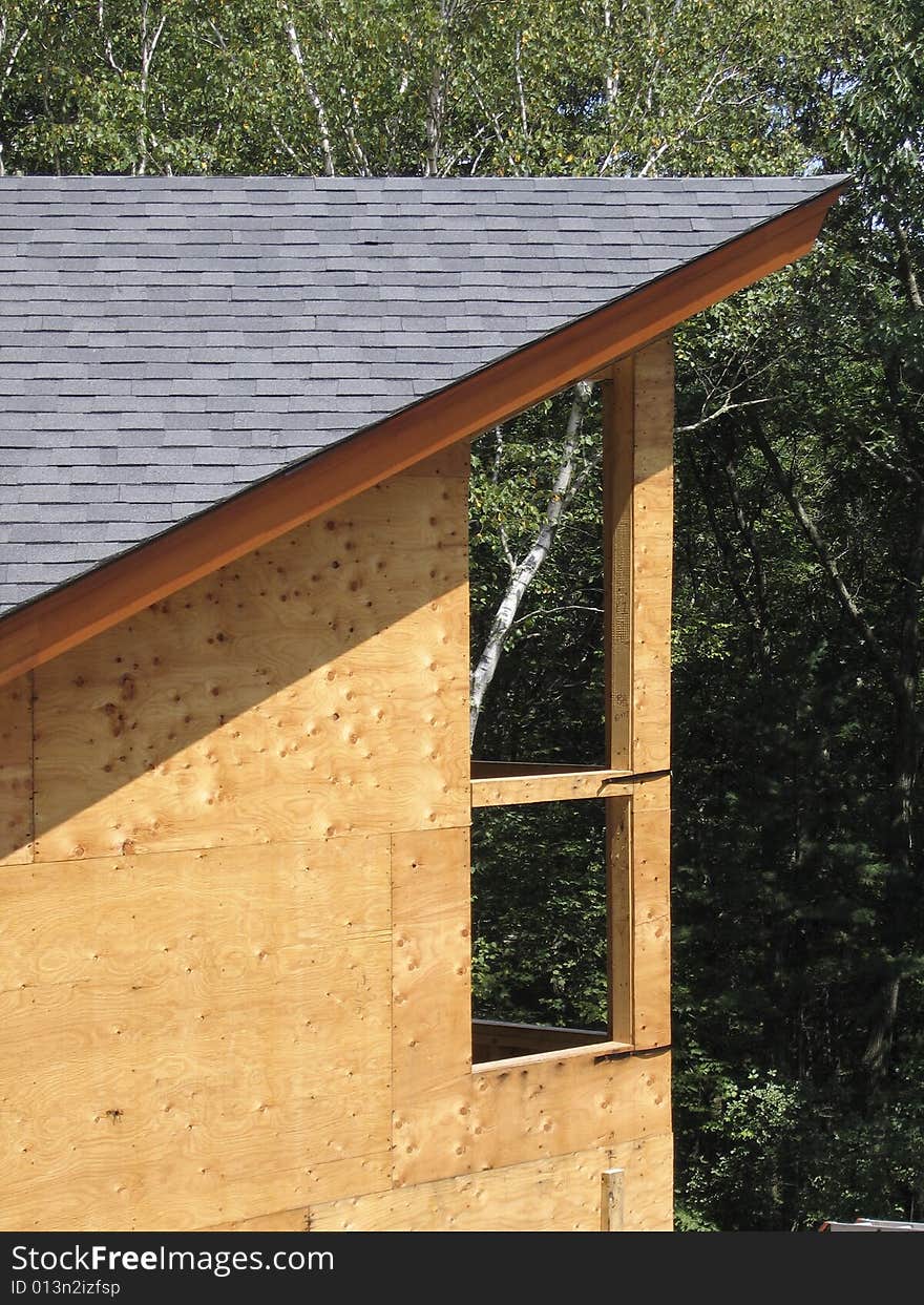 Construction showing completed roof, with sheathed but un-sided walls, and frames for windows. Construction showing completed roof, with sheathed but un-sided walls, and frames for windows.