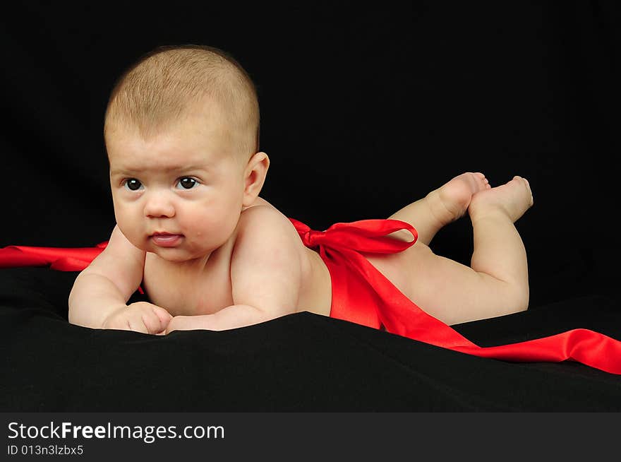 A little cute baby portrait over black. A little cute baby portrait over black