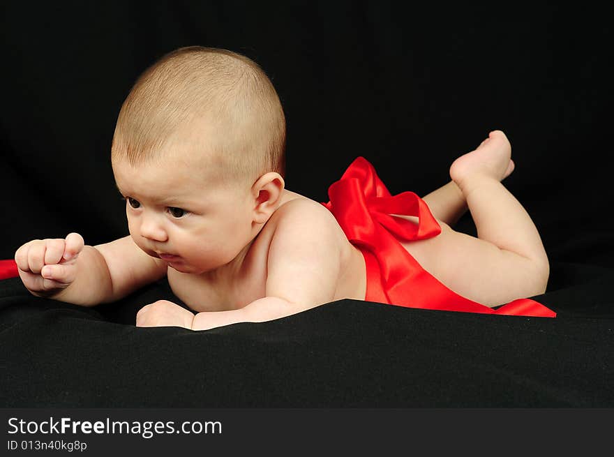 A little cute baby portrait over black. A little cute baby portrait over black