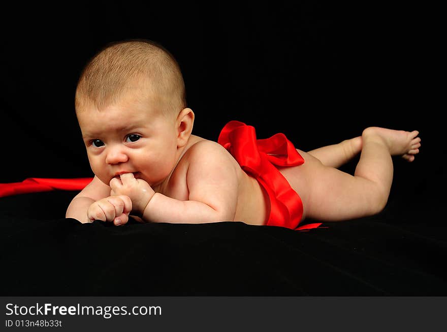 A little cute baby portrait over black. A little cute baby portrait over black