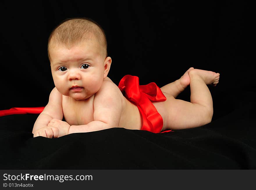 A little cute baby portrait over black. A little cute baby portrait over black