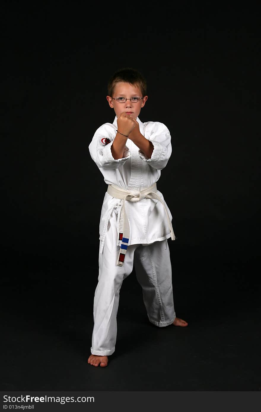 Young boy in traditional karate right stance. Young boy in traditional karate right stance