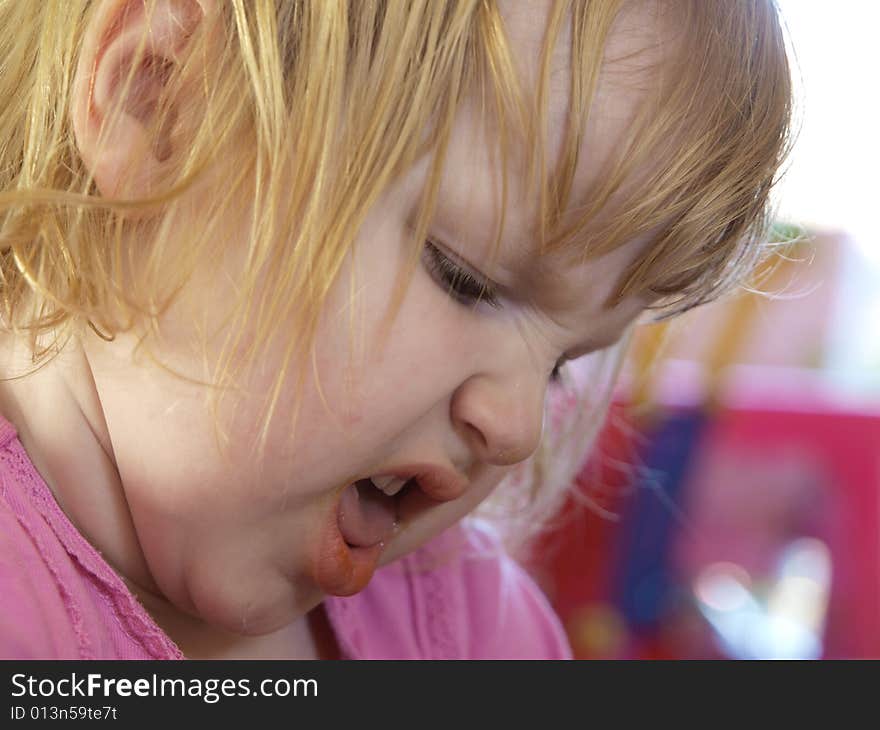 A toddler making yucky faces over a food they dislike.