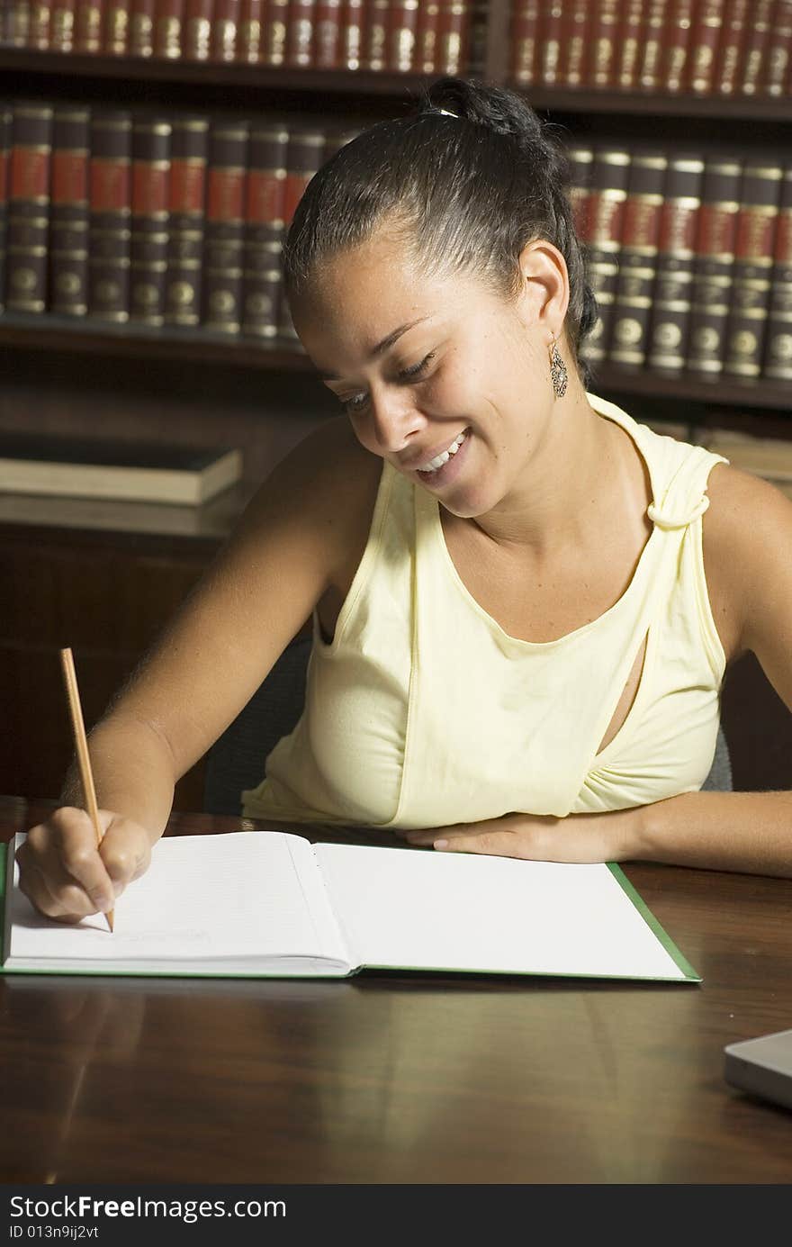 Woman Seated At Desk- Vertical