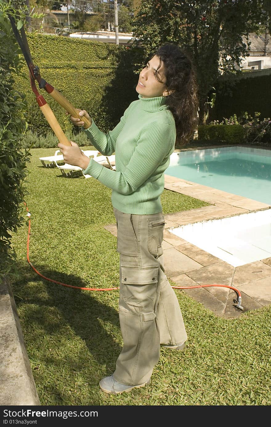 Woman Cutting Shrub