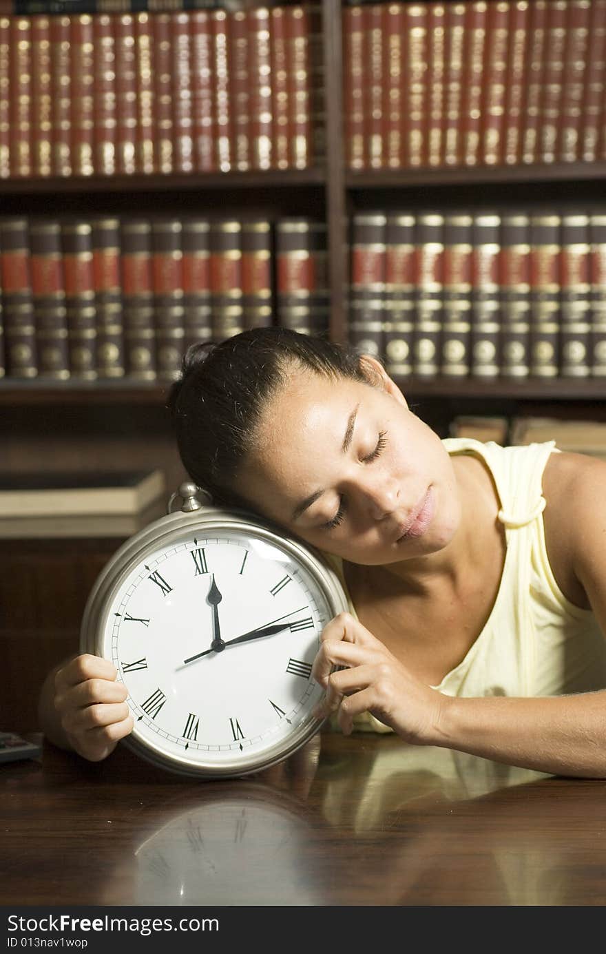 Female student sleeping in an office on a clock. Vertically framed photo. Female student sleeping in an office on a clock. Vertically framed photo.