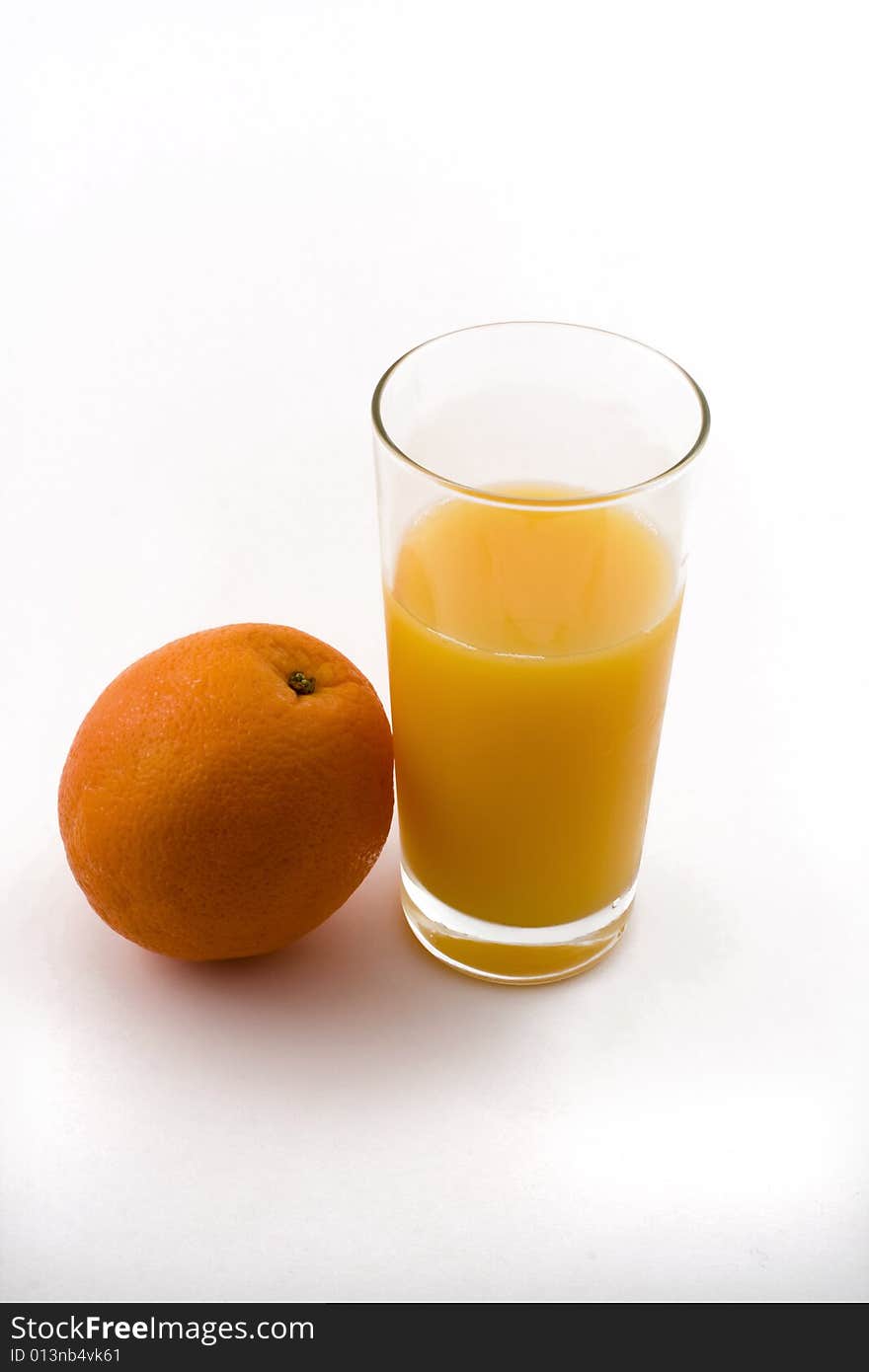 Orange and refreshing glass of orange juice. Orange and refreshing glass of orange juice