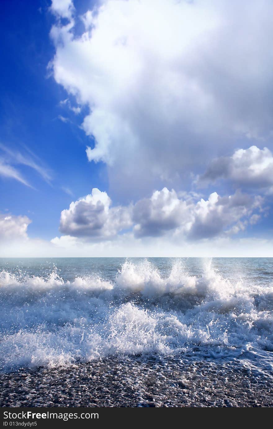 Wave on sea beach under year blue sky and cloud