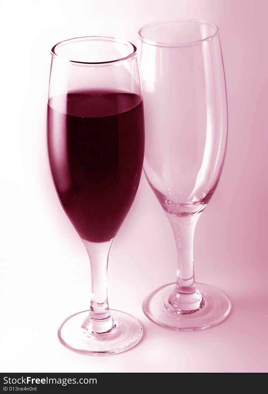 A glass of red wine with a empty glass