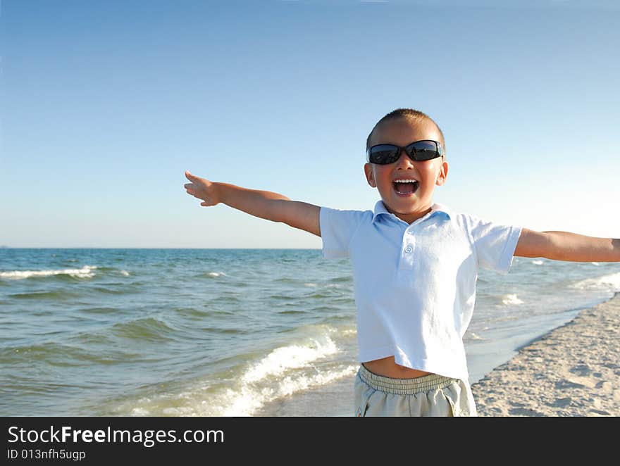 Happy little boy playing on the beach. Happy little boy playing on the beach