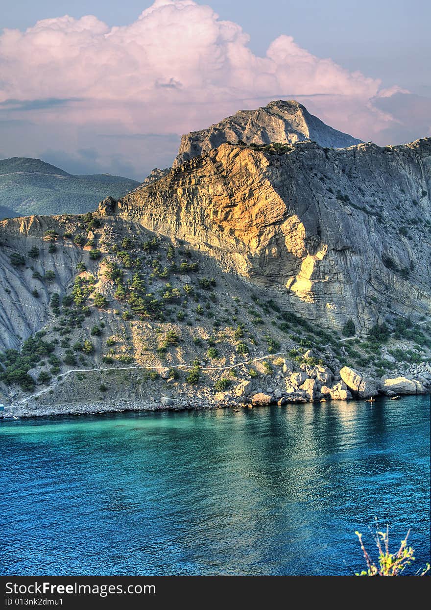 Hdr image of evening sea landscape with red clouds and bay