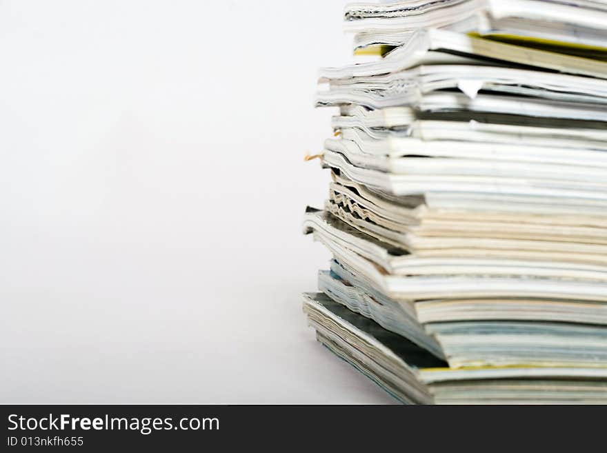 Stack of magazines on neutral background closeup