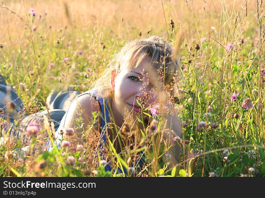 Beautiful woman relaxing on a meadow