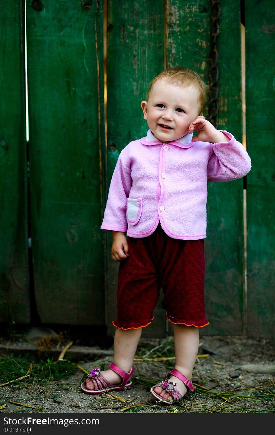 Baby-girl near fence