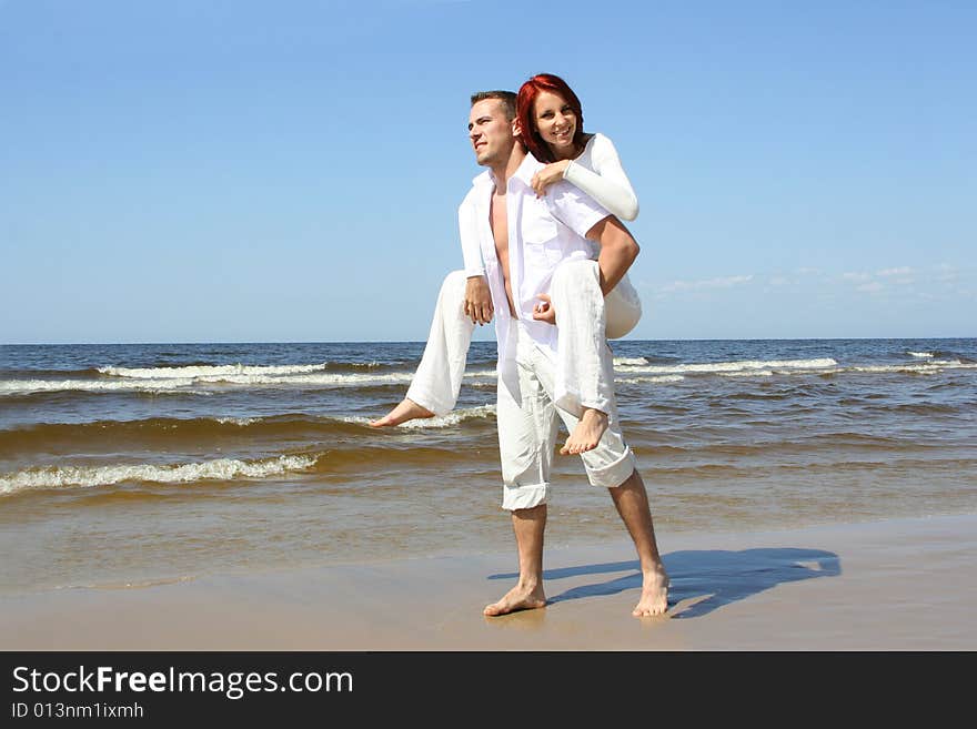 Beautiful yound couple relaxing on the beach. Beautiful yound couple relaxing on the beach