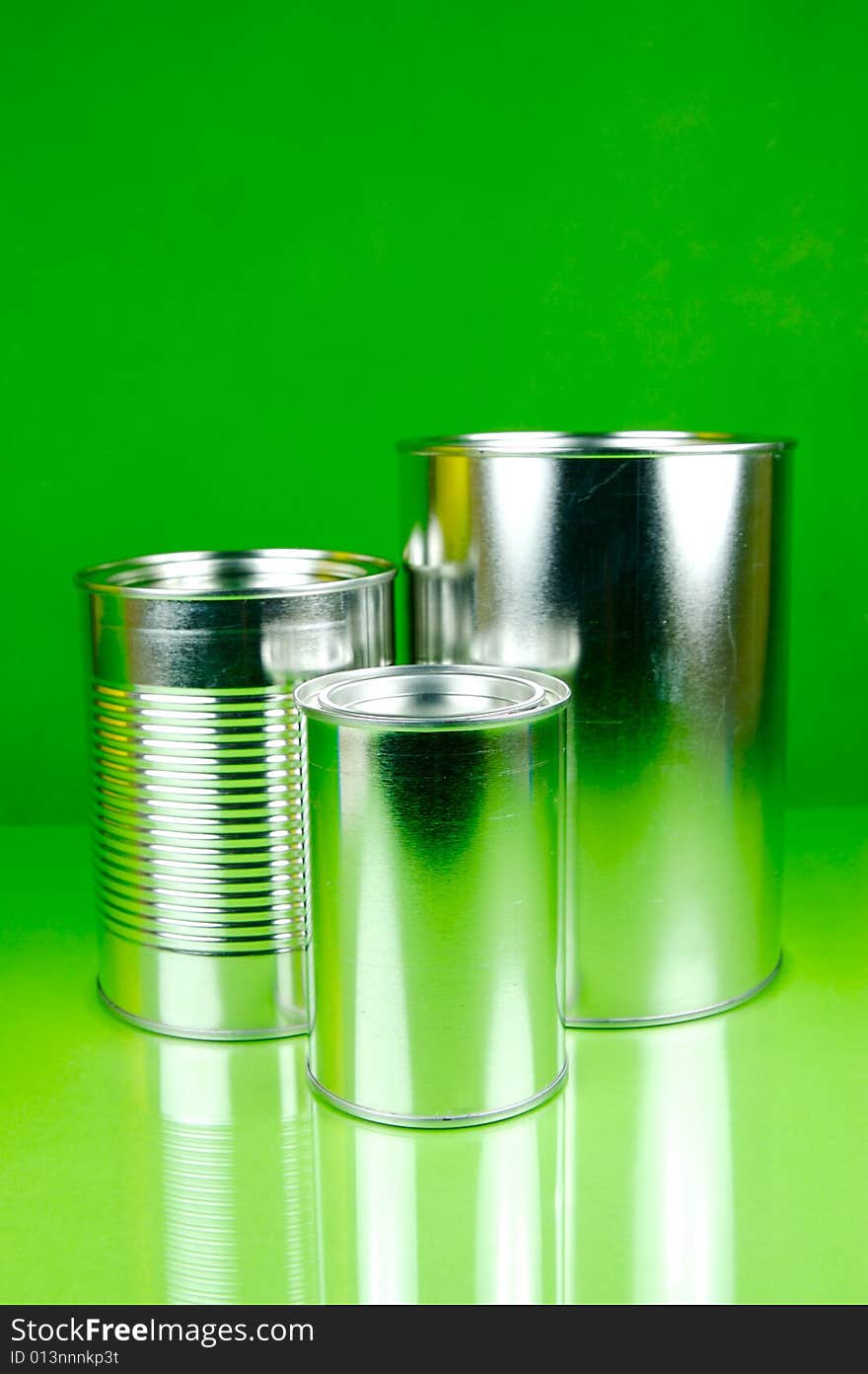 Assorted tins isolated against a green background. Assorted tins isolated against a green background