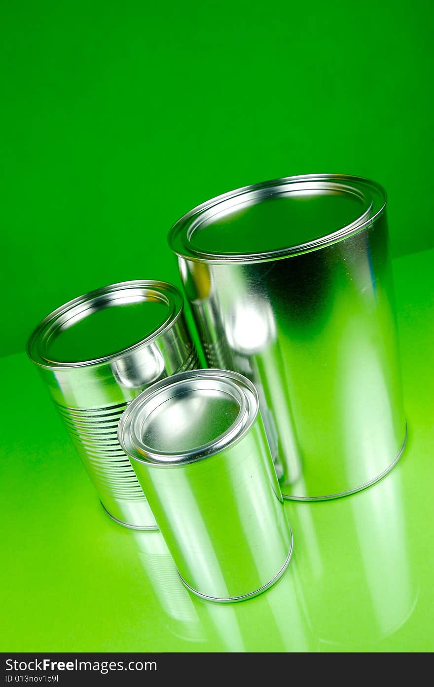 Assorted tins isolated against a green background. Assorted tins isolated against a green background