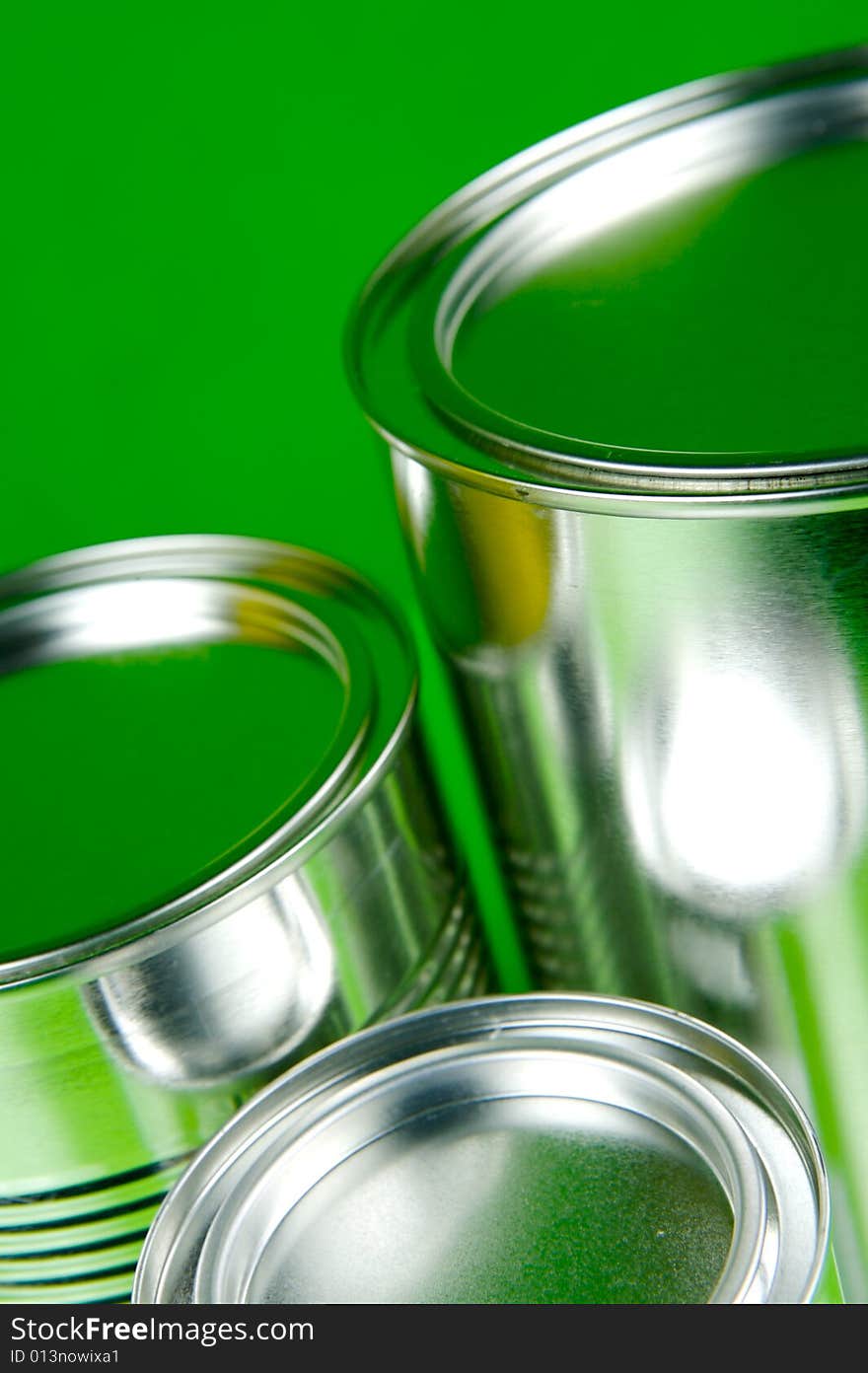 Assorted tins isolated against a green background. Assorted tins isolated against a green background