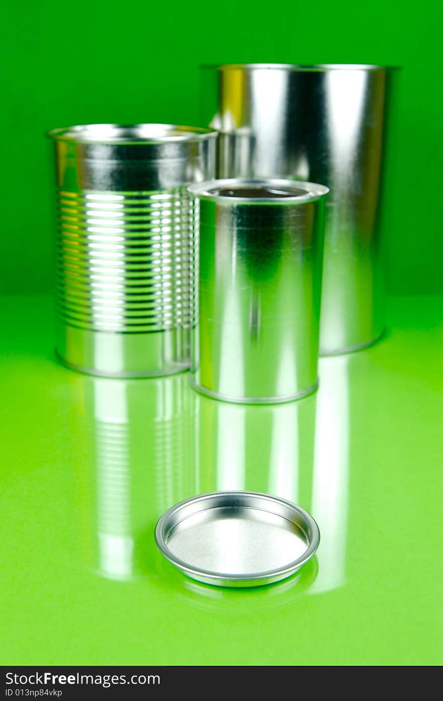 Assorted tins isolated against a green background. Assorted tins isolated against a green background