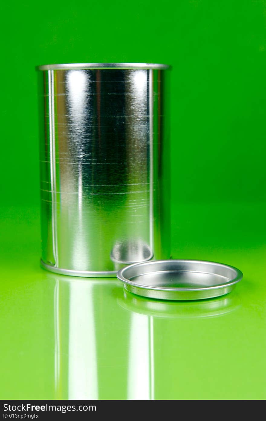 Assorted tins isolated against a green background. Assorted tins isolated against a green background