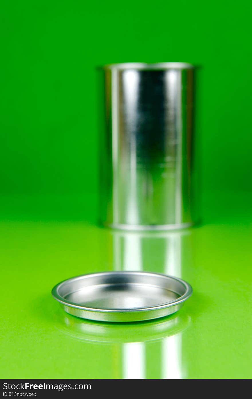 Assorted tins isolated against a green background. Assorted tins isolated against a green background