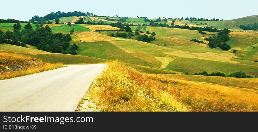 Green yellow meadows and fields over hills. Green yellow meadows and fields over hills