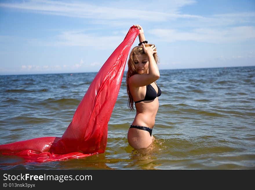 Beautiful girl swimming with red shawl