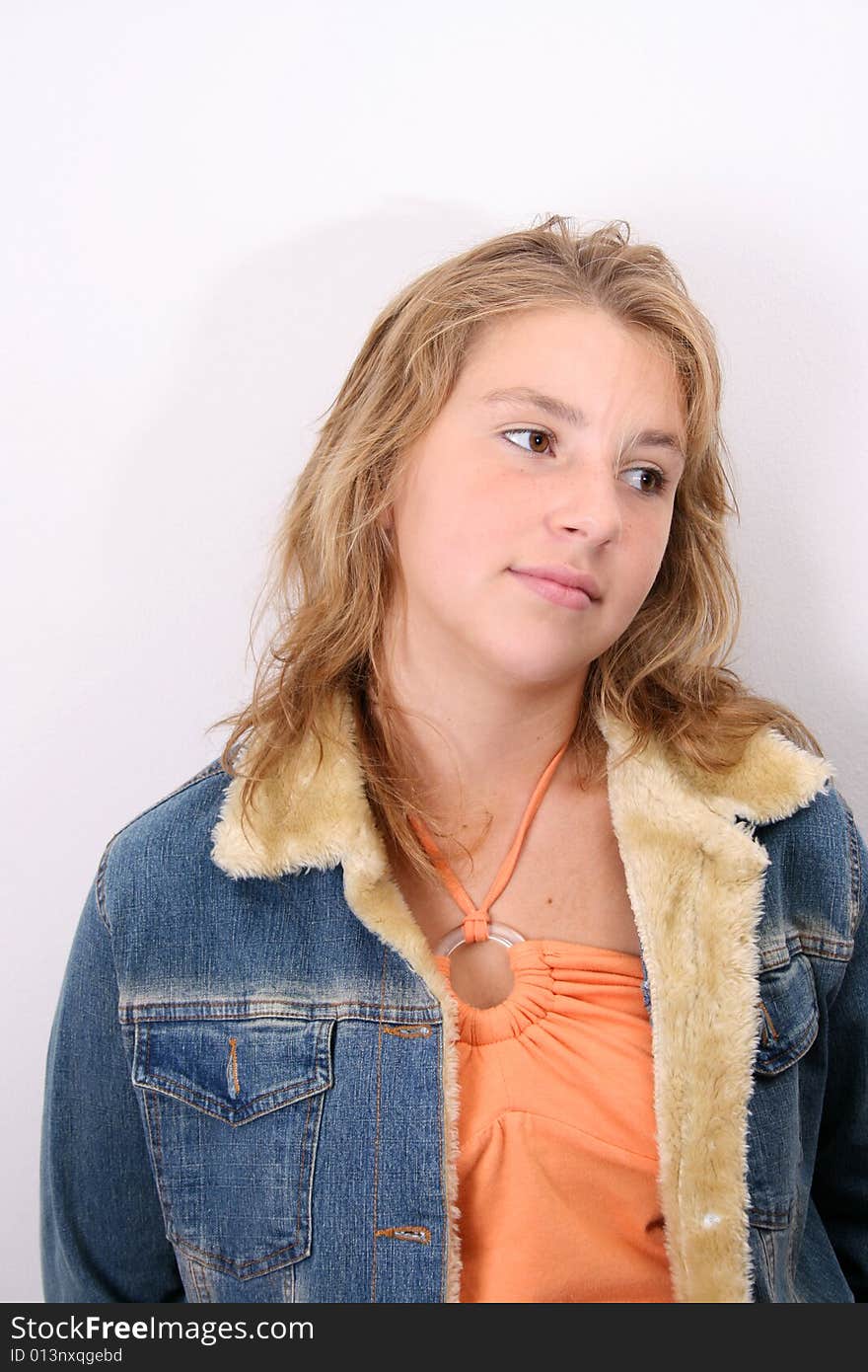 Teenage female model leaning against a white wall. Teenage female model leaning against a white wall