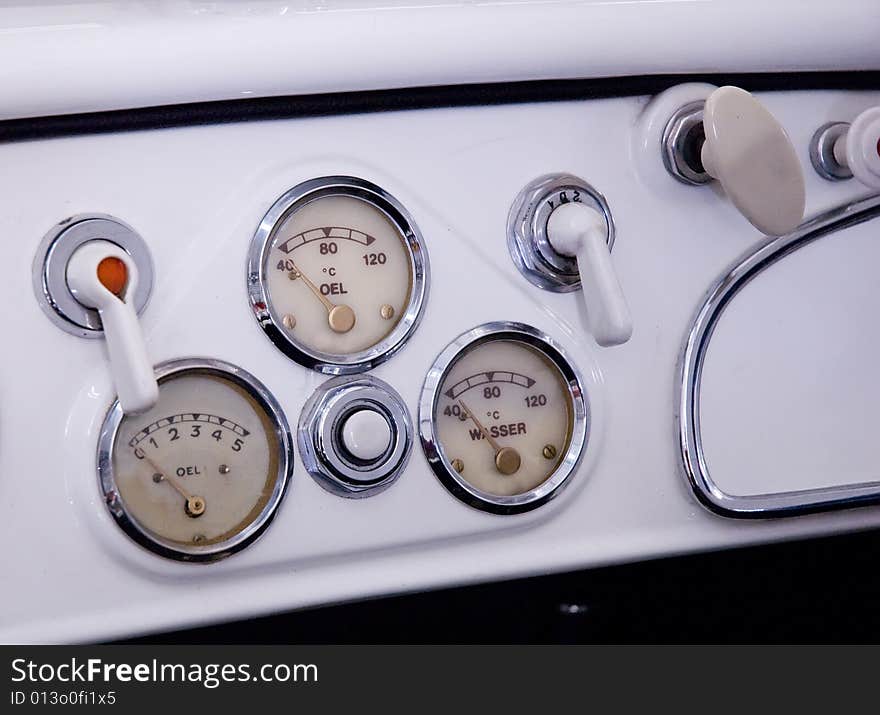 Some litle dials and knobs on an old sheet steel dashboard. Some litle dials and knobs on an old sheet steel dashboard