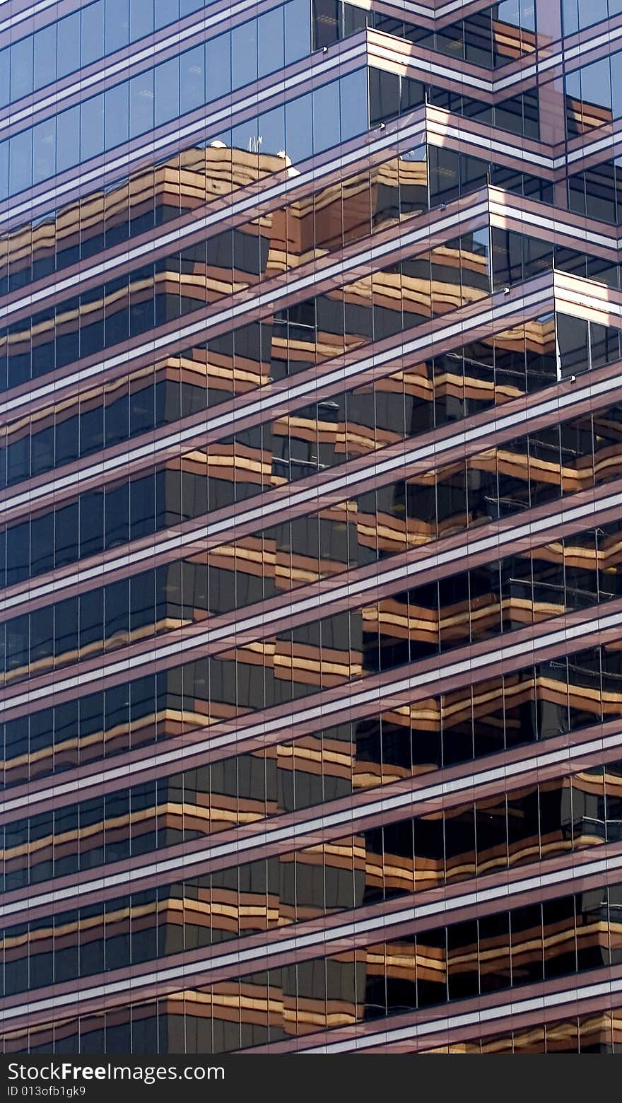 A modern glass brown reflective building with many angles. A modern glass brown reflective building with many angles