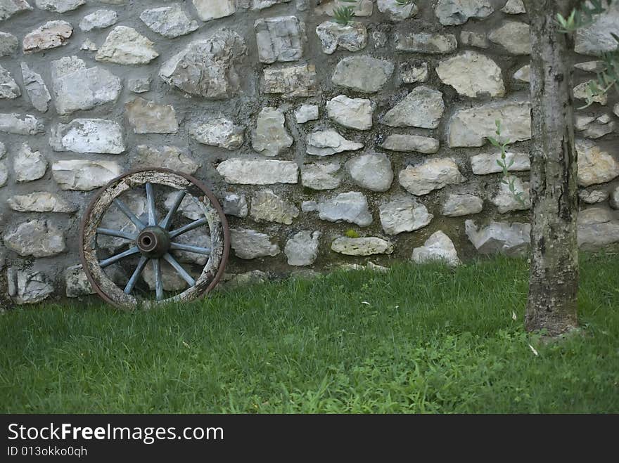 A wall with an ancient wheel. A wall with an ancient wheel