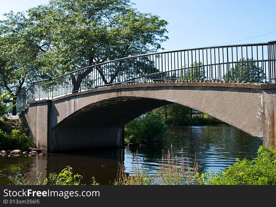 Scenic walking bridge arches over the charles river in boston massachusetts on a clear summer day