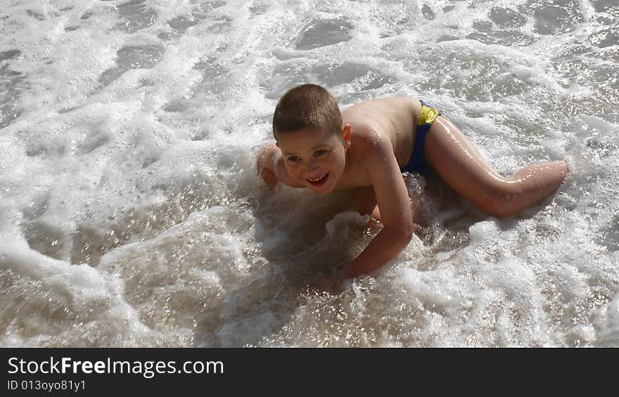 Happy child playing on the beach