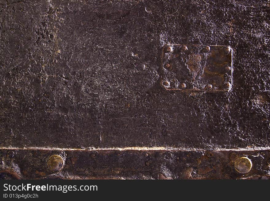 Detail of an old furniture covered by black leather. Detail of an old furniture covered by black leather