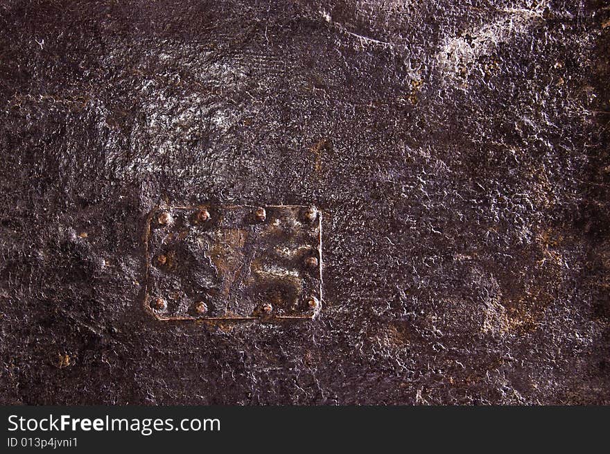 Detail of an old furniture covered by black leather. Detail of an old furniture covered by black leather