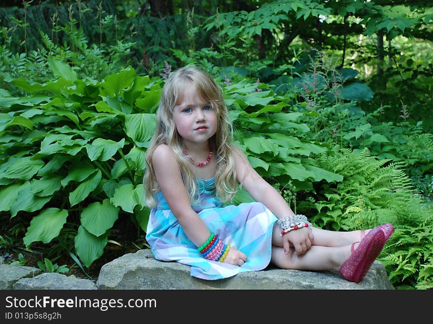 A portrait of a young girl in a garden. A portrait of a young girl in a garden.