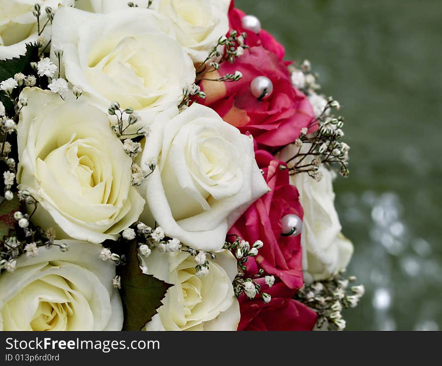 Close-up of wedding bouquet with beige and red roses