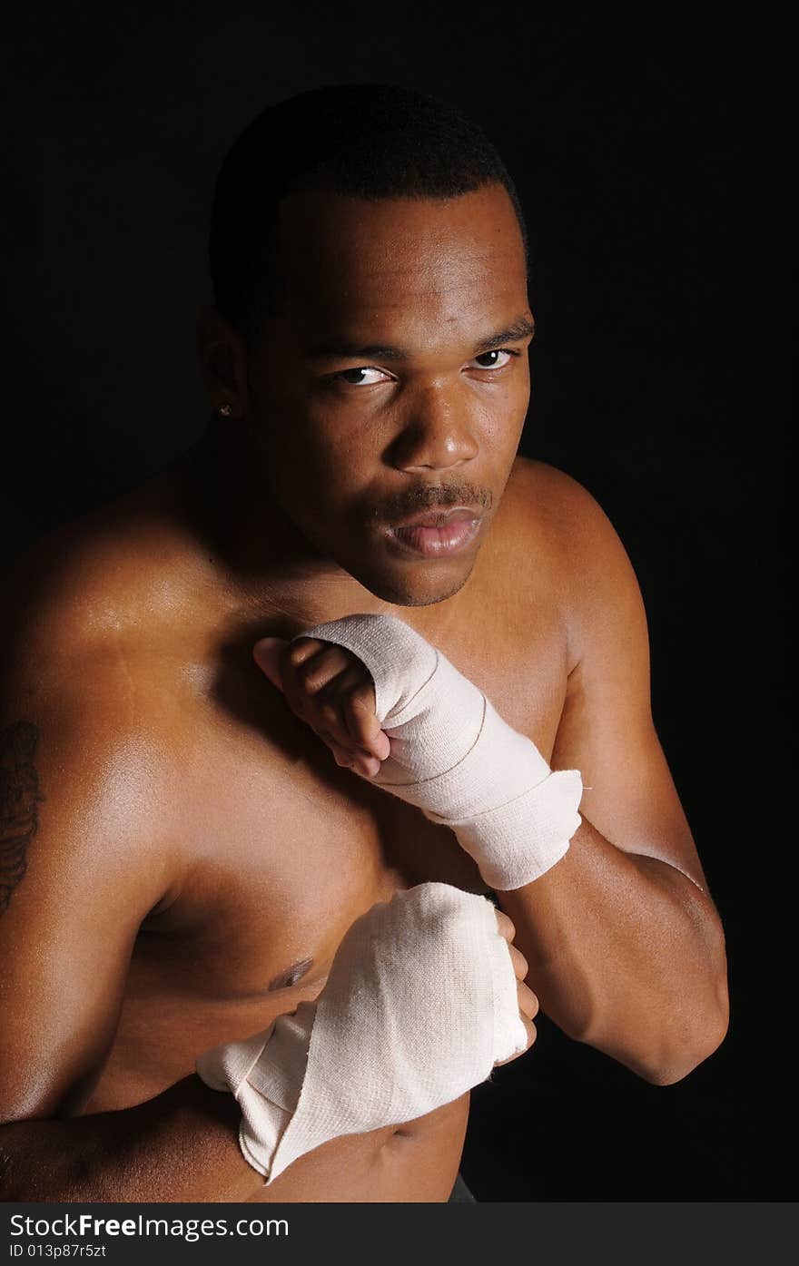 African american boxer with hands in bandages, warming up