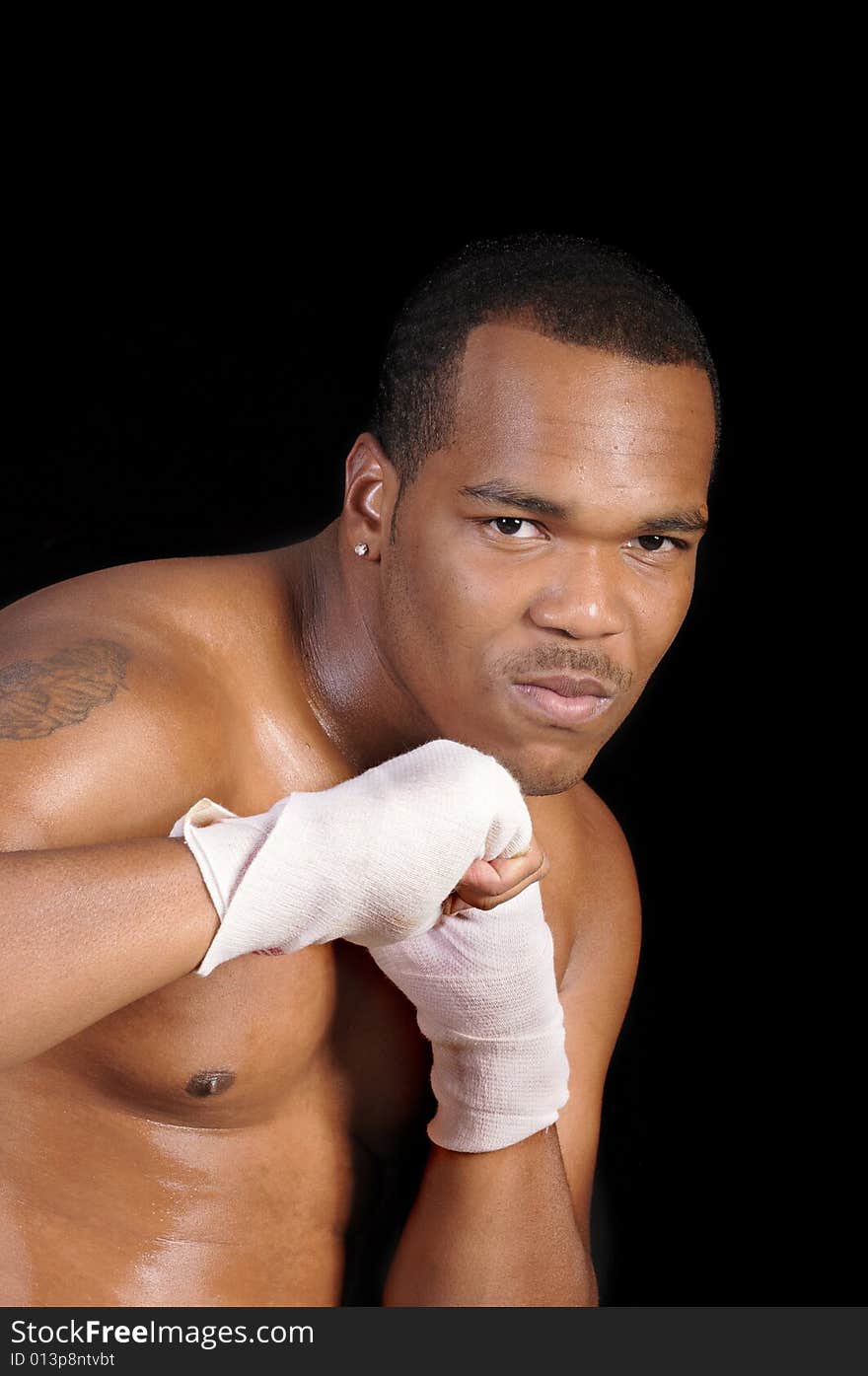 African american boxer warming up over a black background