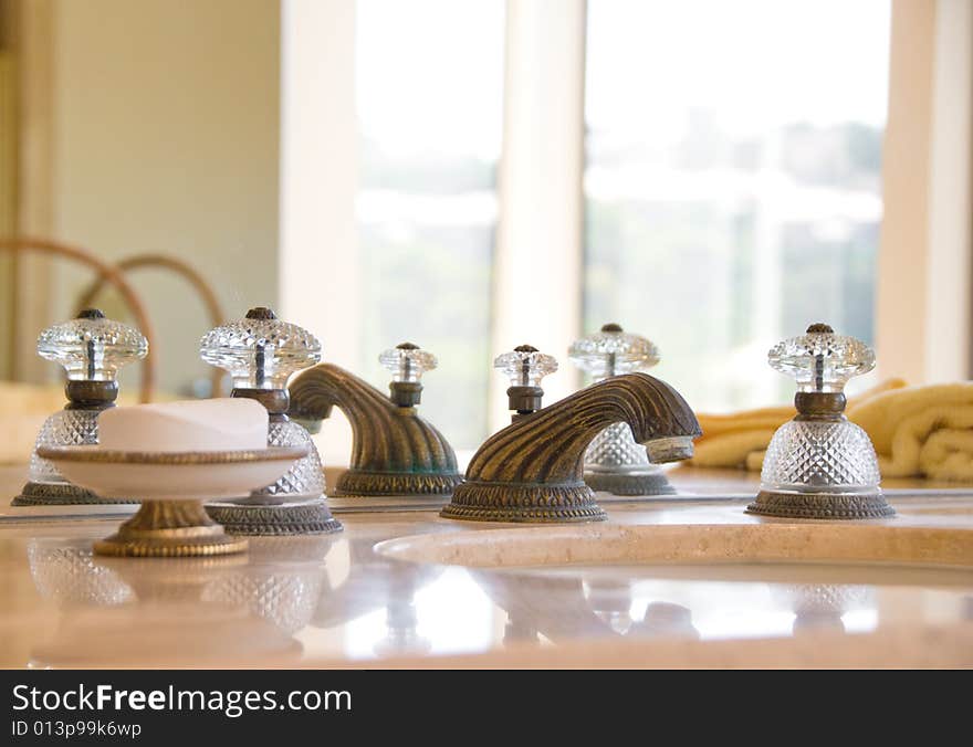 Granite counter sink with old fashioned faucet and handles in a La Jolla mansion. Granite counter sink with old fashioned faucet and handles in a La Jolla mansion.