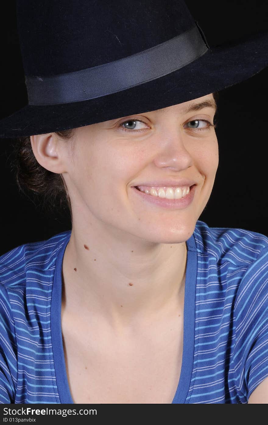 Beautiful russian woman in closeup with hat on isolated on black