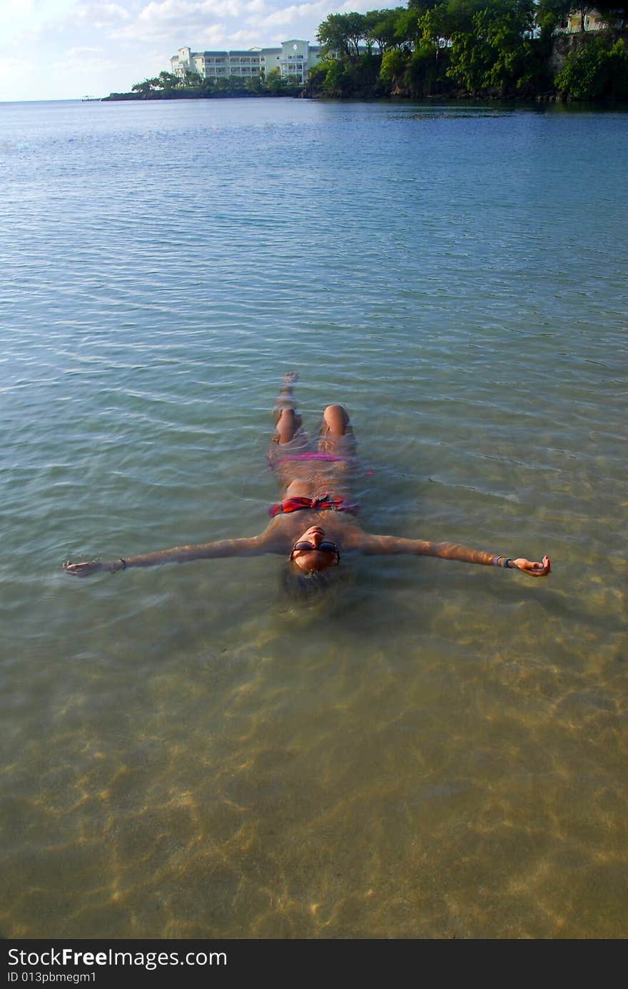 A girl relaxing in the warm tropical water. A girl relaxing in the warm tropical water