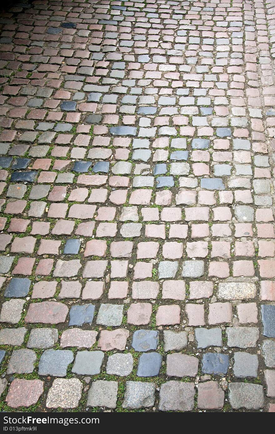 Medieval pavement side walk with square bricks