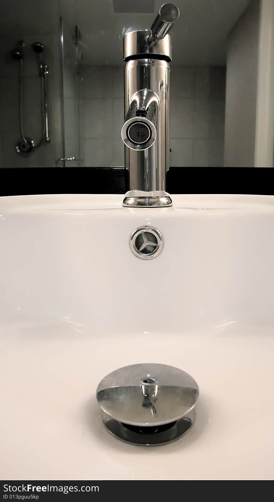 Detail of Modern Faucet and Sink in Bathroom. Detail of Modern Faucet and Sink in Bathroom