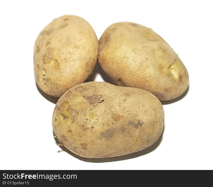 Three crude potatoes on a white background. Three crude potatoes on a white background