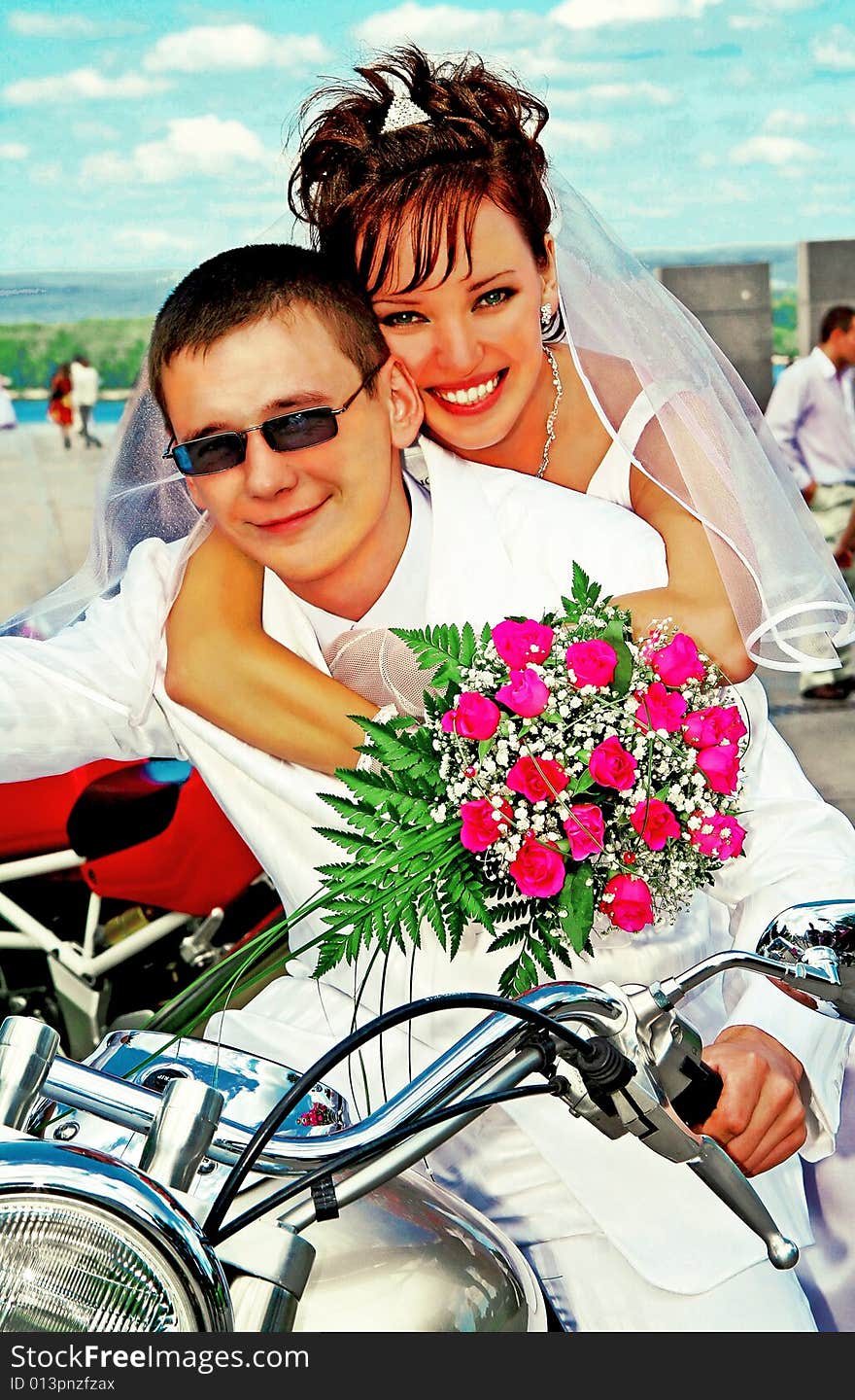 Bridegroom and bride on the motorcycle