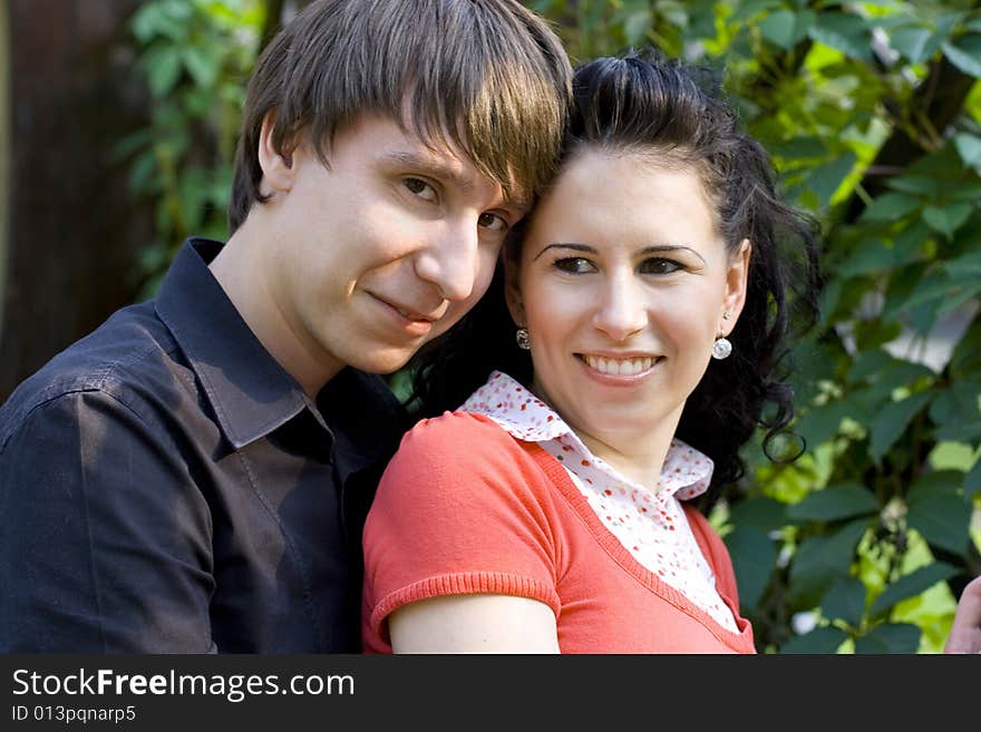 Outdoor portrait of young happy attractive couple together. Outdoor portrait of young happy attractive couple together